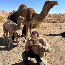 Joel Richardson having a snack with camels