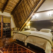 south africa safari lodging thatched roof cottage