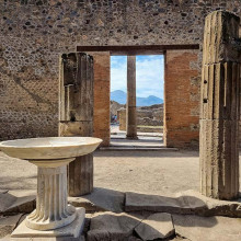 Pompeii ruins with the Vesuvius volcano seen through a doorway unsplash