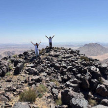 hikers celebrating as they made it to the blackened top of Mount Sinai in Arabia hikers celebrating as they made it to the blackened top of Mount Sinai in Arabia
