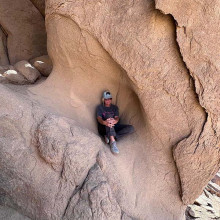 woman having a quiet moment in prayer while climbing the split rock of Horeb woman having a quiet moment in prayer while climbing the split rock of Horeb