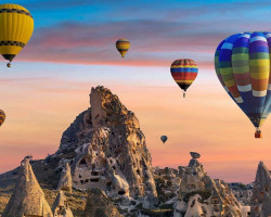 Cappadocia Sunrise Balloon Ride โ A Bucket-List Adventureโ Hot air balloons soaring over Cappadocia's fairy chimneys at sunrise