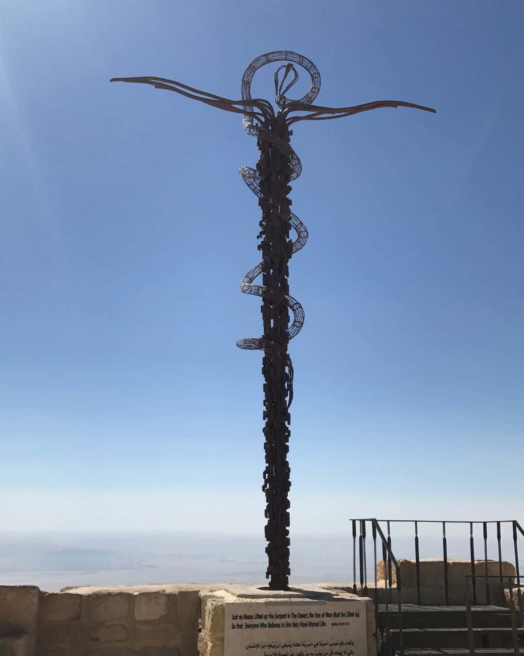Brazen Serpent Monument at Mount Nebo, Jordan, a bronze serpent coiled around a cross above the Promised Land.