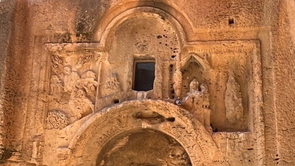 Weathered sixth-century relief carved above a rock-cut tomb entrance at Dara, southeastern Turkey, showing the prophet Ezekiel and the valley of dry bones.