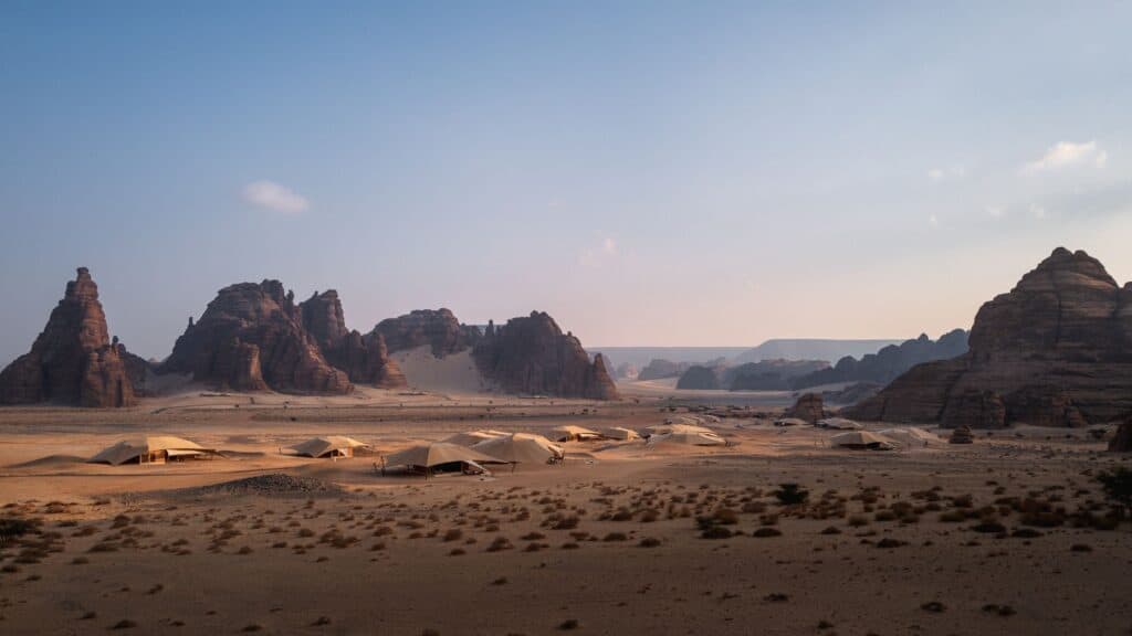 Luxury tented villas of Banyan Tree AlUla spread across the Ashar Valley floor, surrounded by sandstone outcrops in AlUla, Saudi Arabia